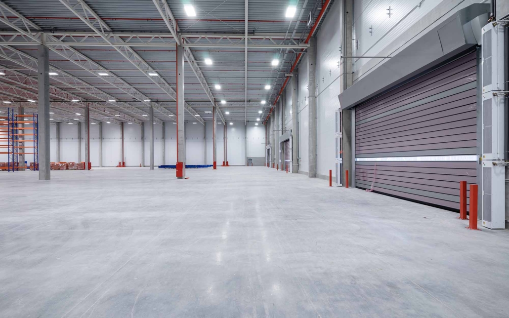 warehouse or hangar. Industrial building interior consist of polished concrete floor and closed door for product display or industry background_