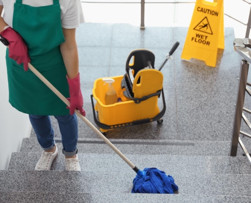 Janitor mopping stairs