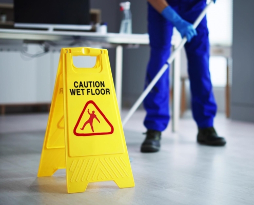 Janitor mopping floor at school