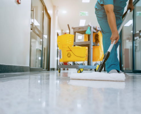 Worker cleaning medical facility