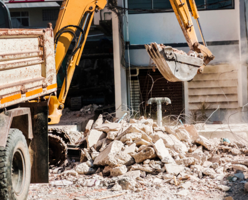 Bulldozer Removes the debris from demolition on the construction site